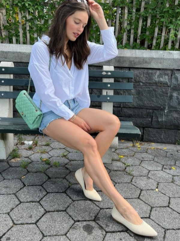 a female influencer sitting on a bench